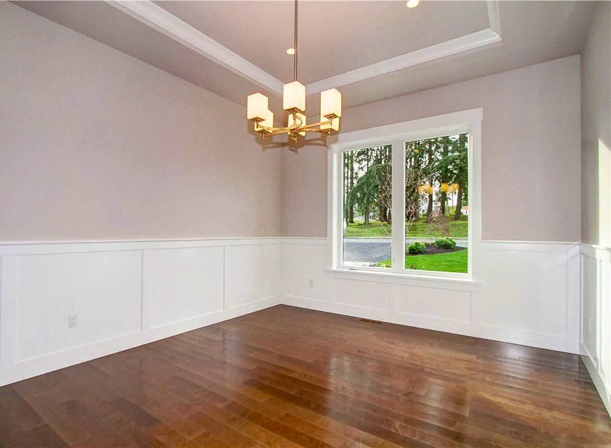 One of the dive bedrooms with wooden floor, chandelier and glass windows.