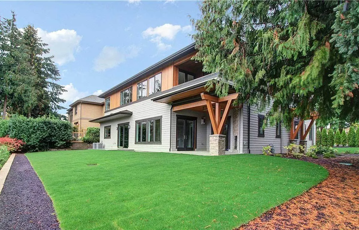 A look of the house from a different angle, showing the side entry to the house and a covered patio.