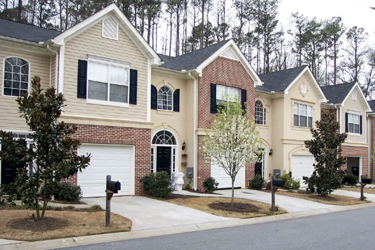 The exterior of a constructed home layout with horizontal siding and red bricks.