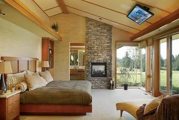 Master bedroom in a sleek elegant interior design with a fireplace area.