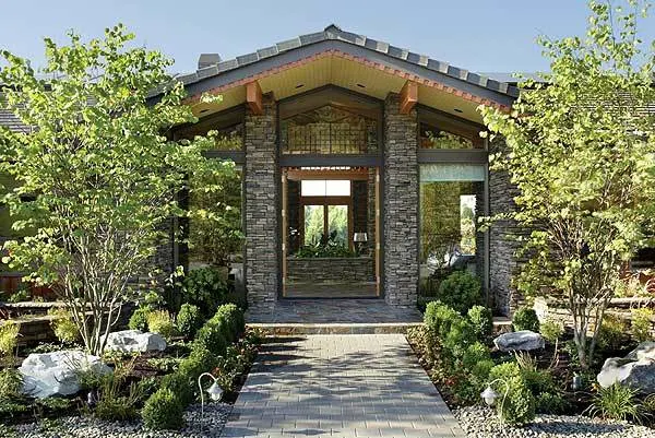 A beautiful stone brick front with a glass door and window.