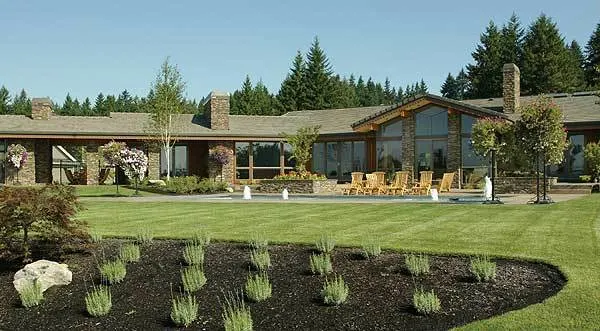 The back of the house has a large yard and a patio space for outdoor leisure.