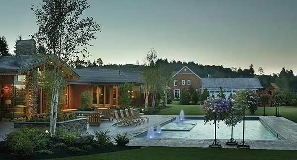 The pool is located at the back, with a hot tub and fountain features.