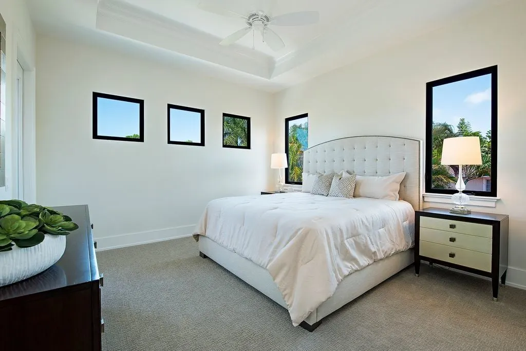 Beautiful window frames with black trim complement the side table design.