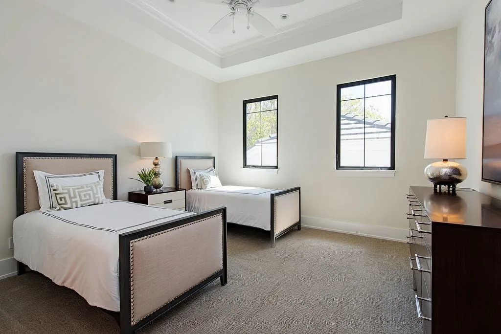 Bedroom with two single beds in a neutral style interior.