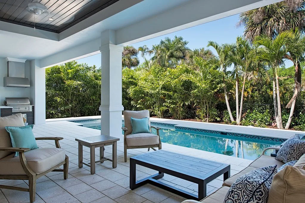 Covered lanai with wooden accent design seat lounges.