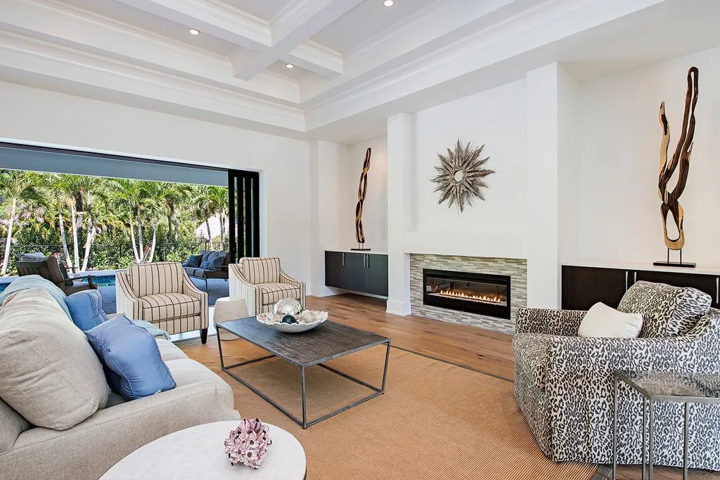 A tiled wall frame surrounds a linear fireplace.
