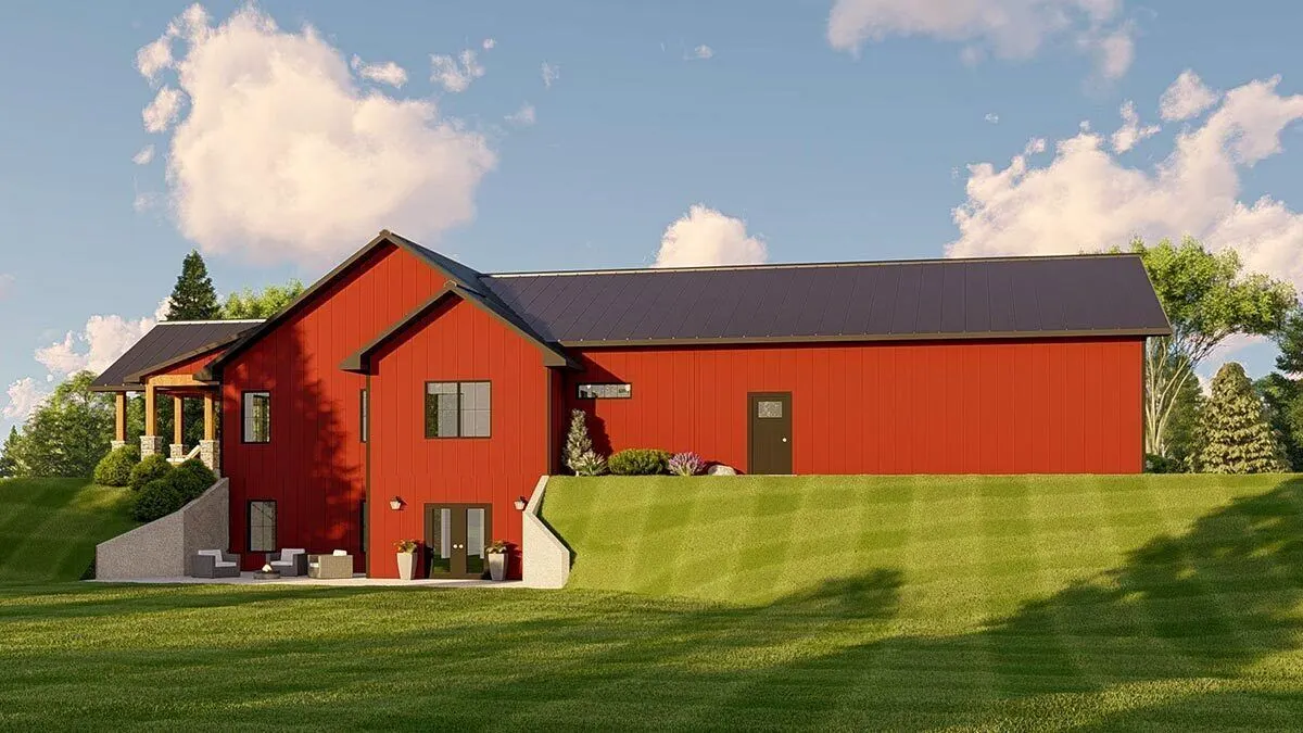 The back of the home has a patio space in a large, open backyard.