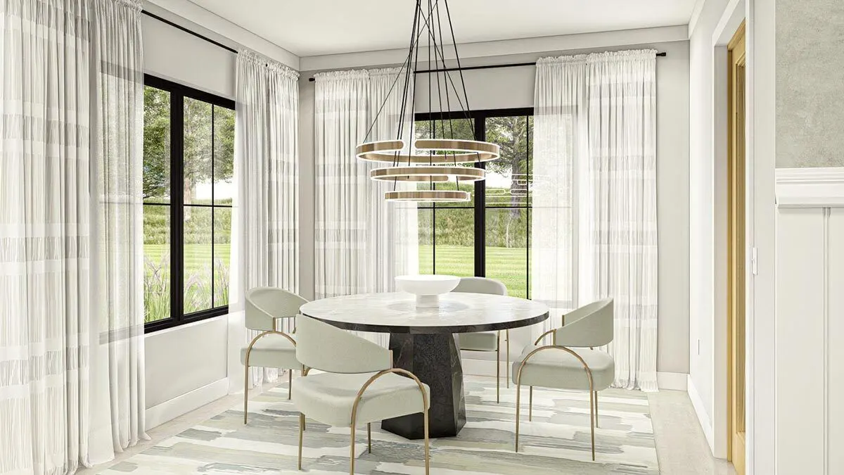 A beautiful chandelier hangs over a gray marble table in the dining room.