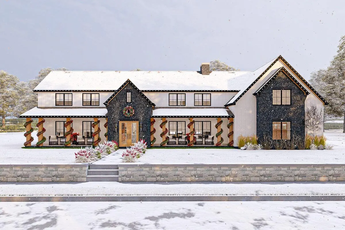 Snow-coated façade of the barndominium with a Christmas motif.
