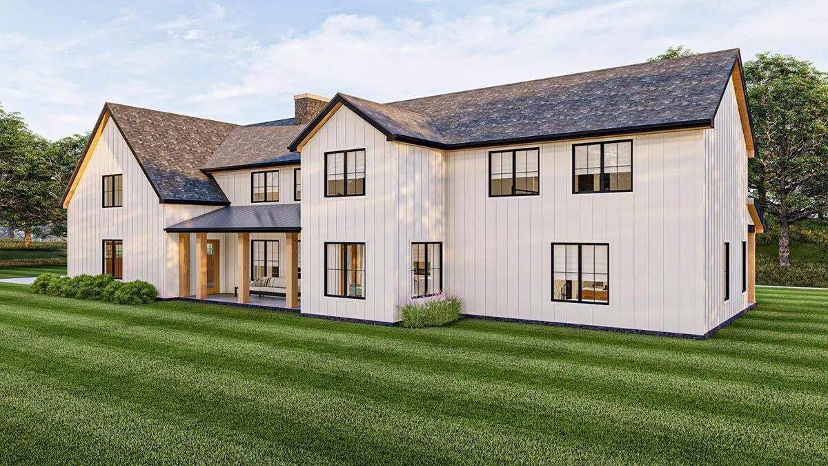 The back perspective of the barndominium additionally features a covered porch.
