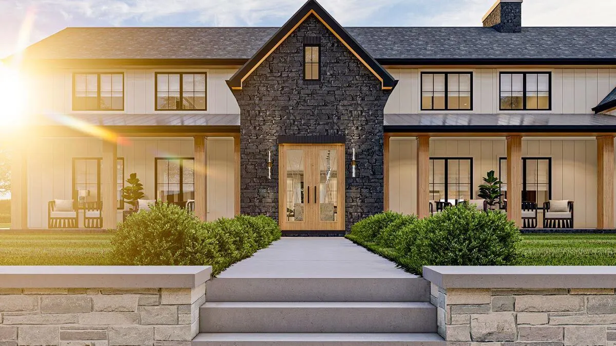 The house's front entry has a black brick stone foundation and a double glass door with a wood accent.