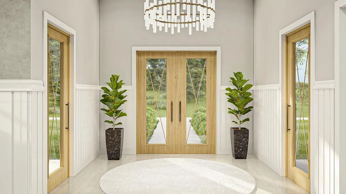 The foyer of the home is decorated in a Nordic style with large plants.