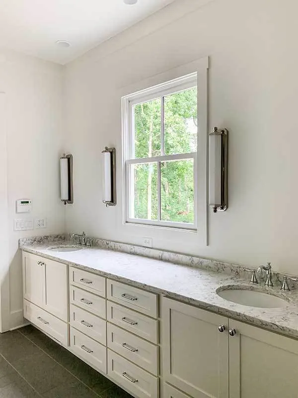 Vanity area with a window view of the outdoor and vertical light design.