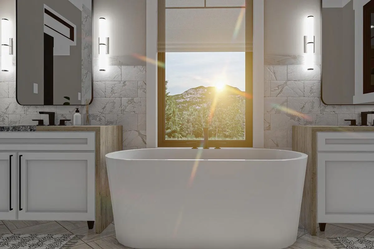 Bathing tub in white near the window with a nice view of the outside.