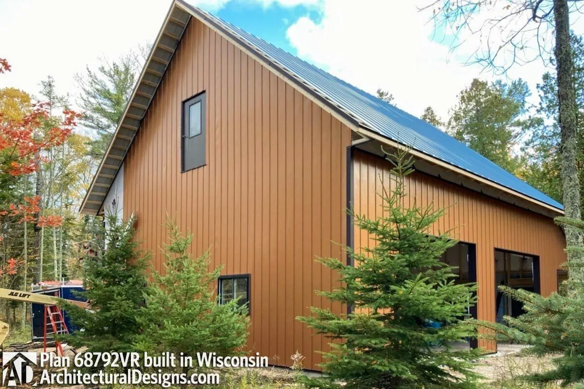 A brown hue wall with blue roofing and a glass door garage design layout.