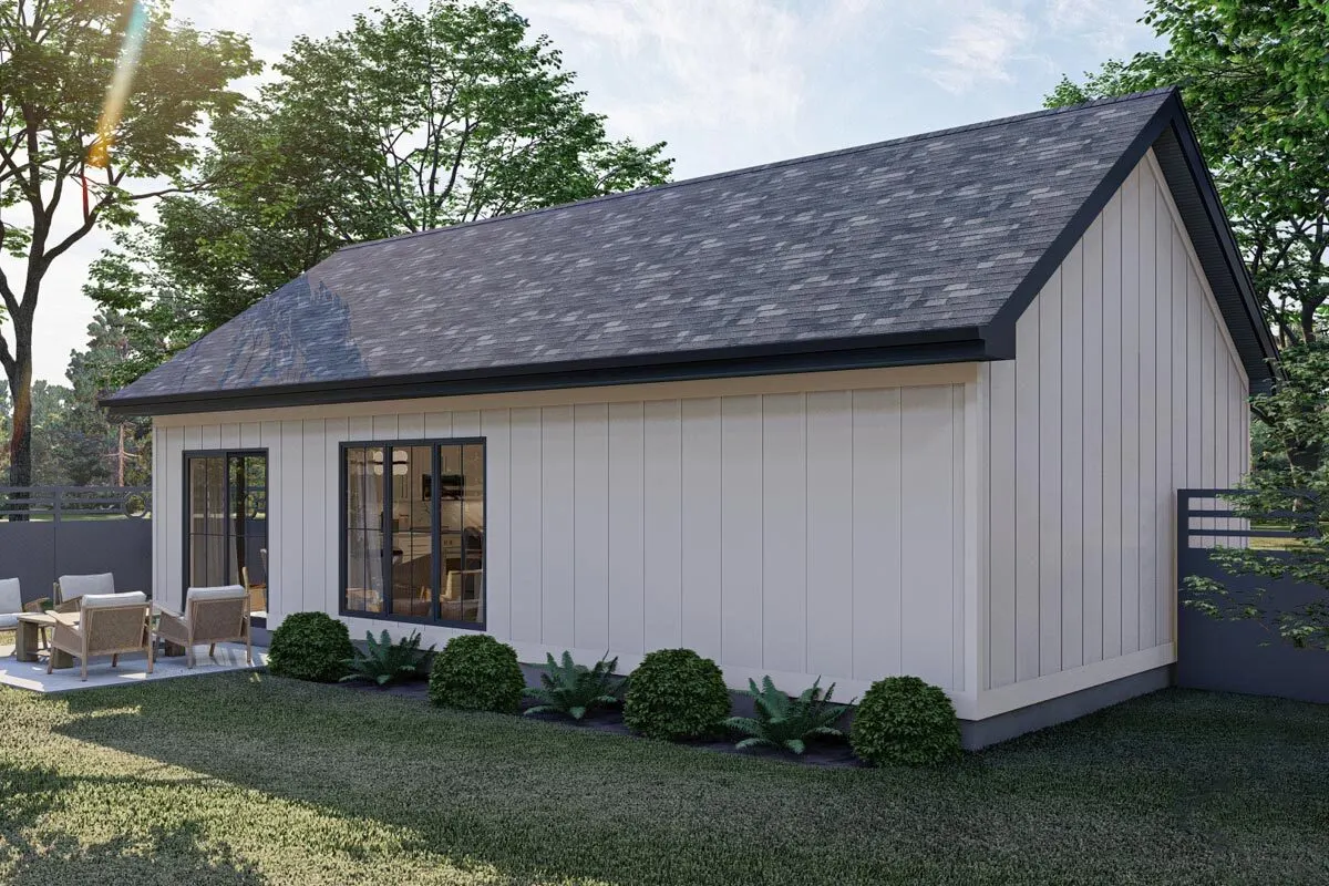 Rear view of the house with a little patio and spacious yard.