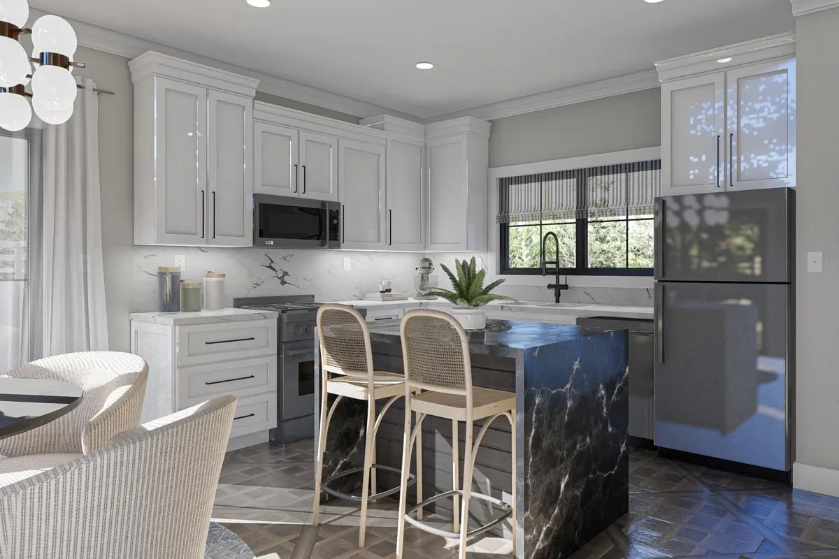 White interior painted cabinets and walls surround a black marble island in the center of the kitchen.