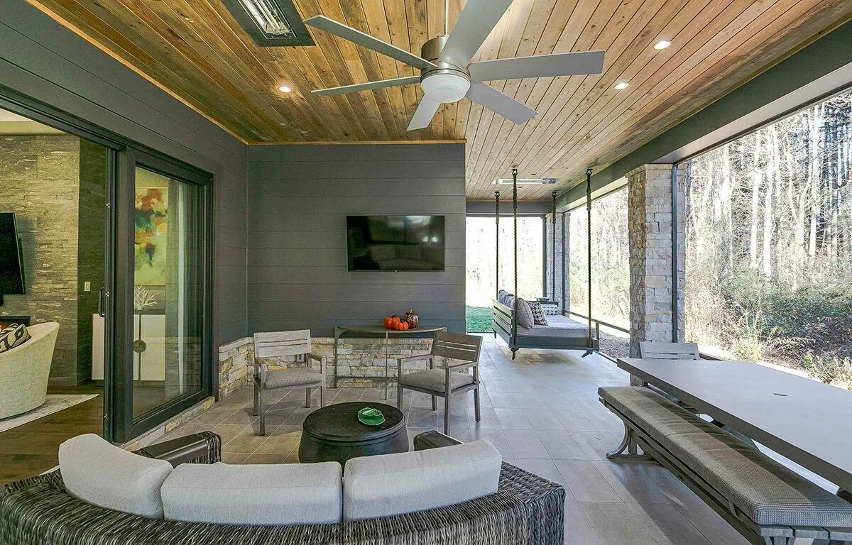 The lanai area has a wood ceiling and a hanging bench.
