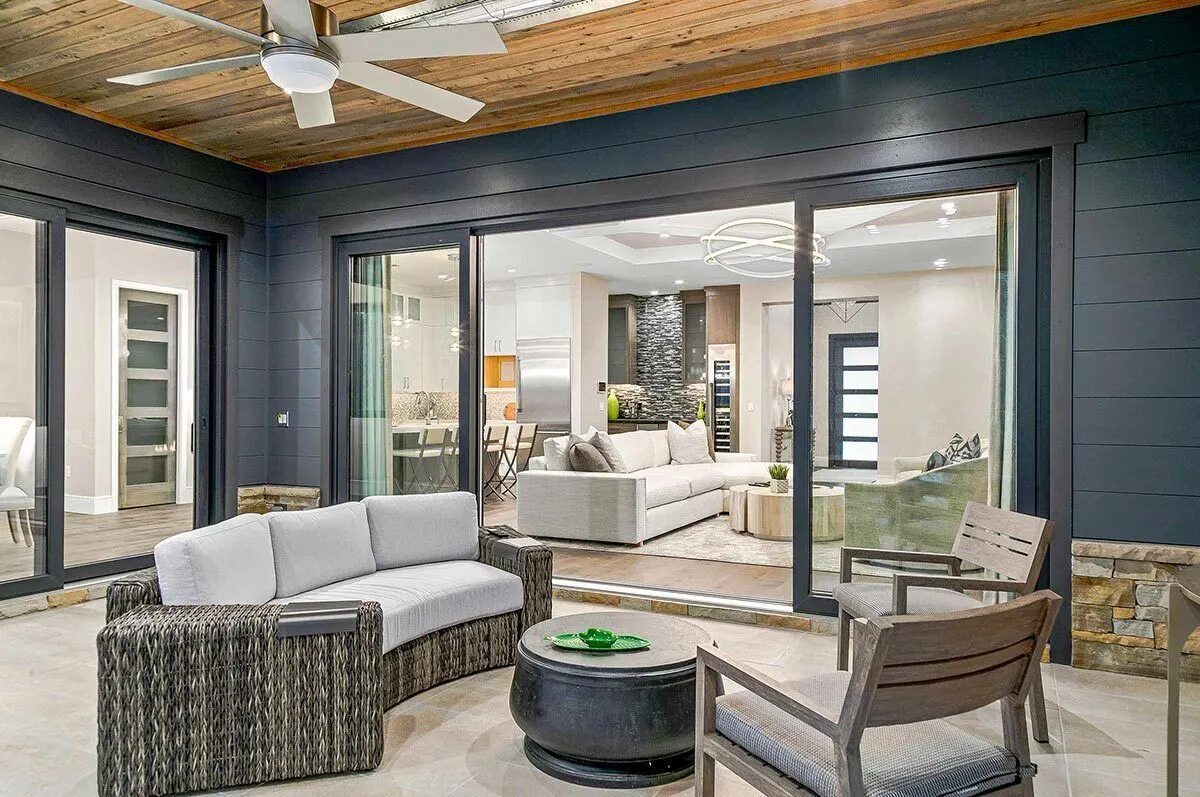 The lanai has a dark gray wall shade and a door slider to the inside.
