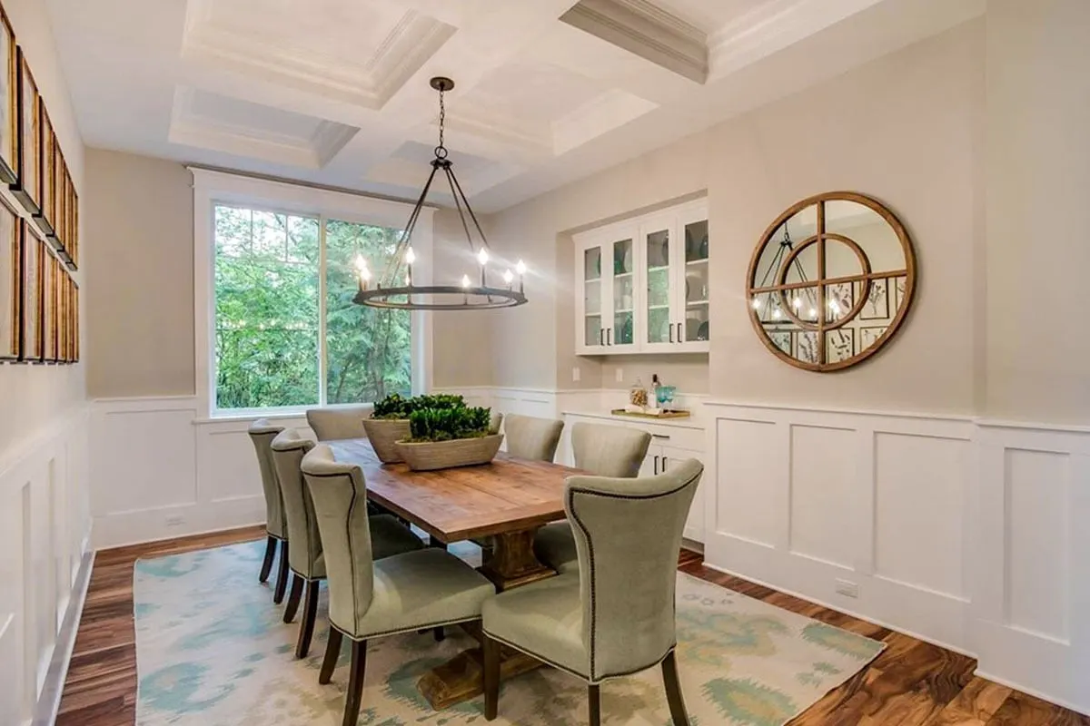 Dining space in elegant interior design with chandelier above.