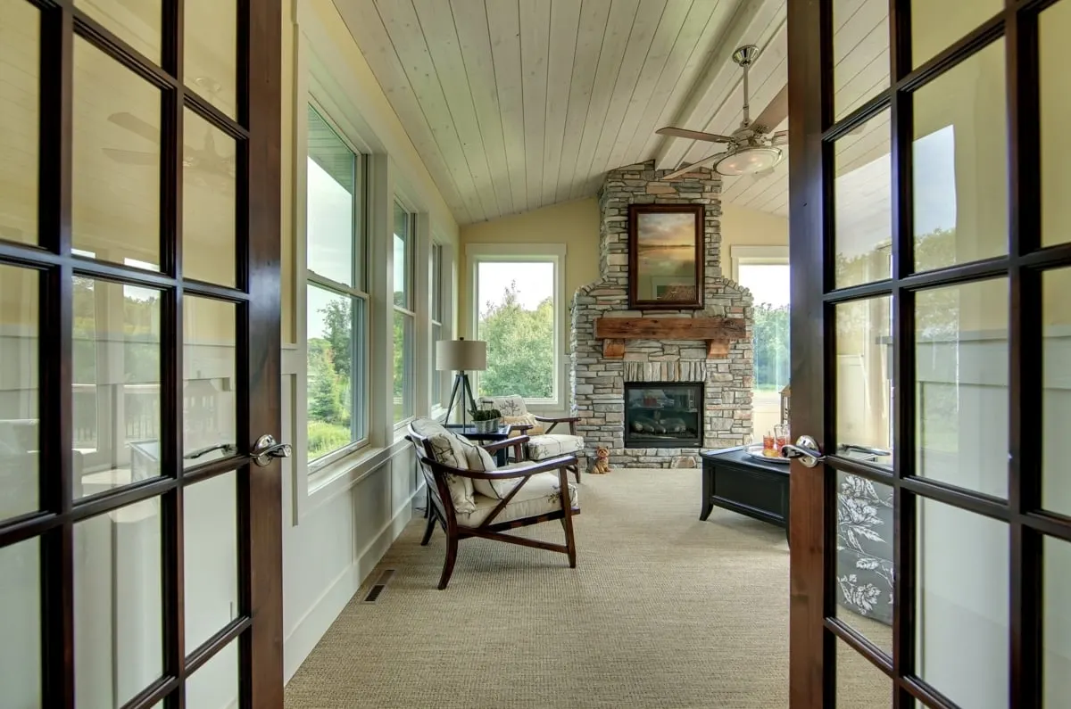 The entry to the four-season porch area features a carpeted floor.