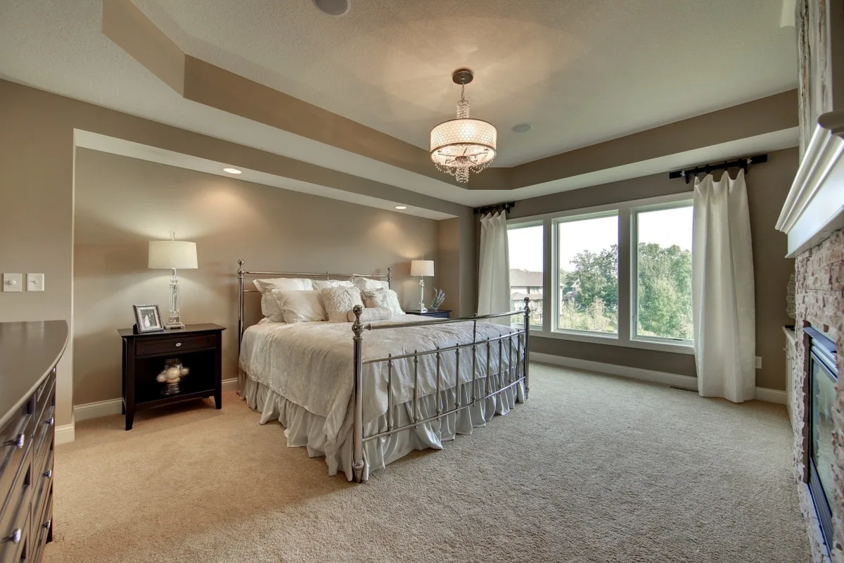 Beautifully designed bedroom with silver accent bed frame and white covers.