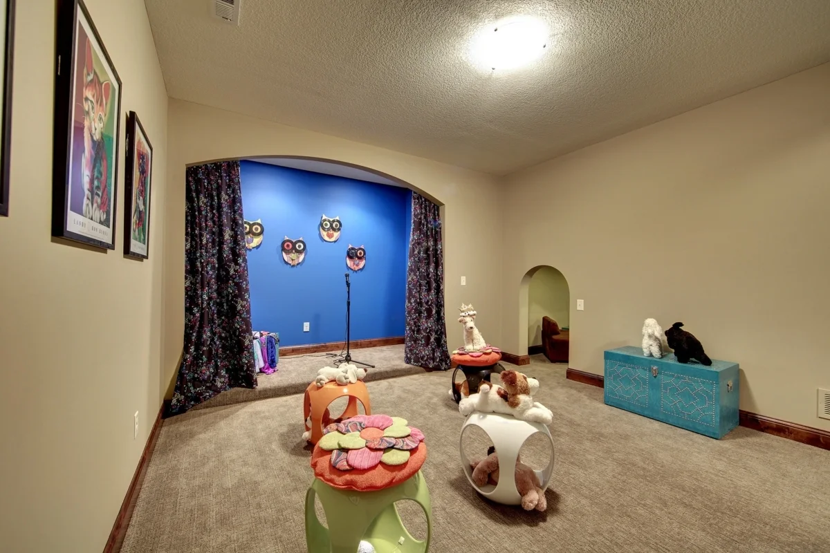 Playroom with stage features and colorful toys.