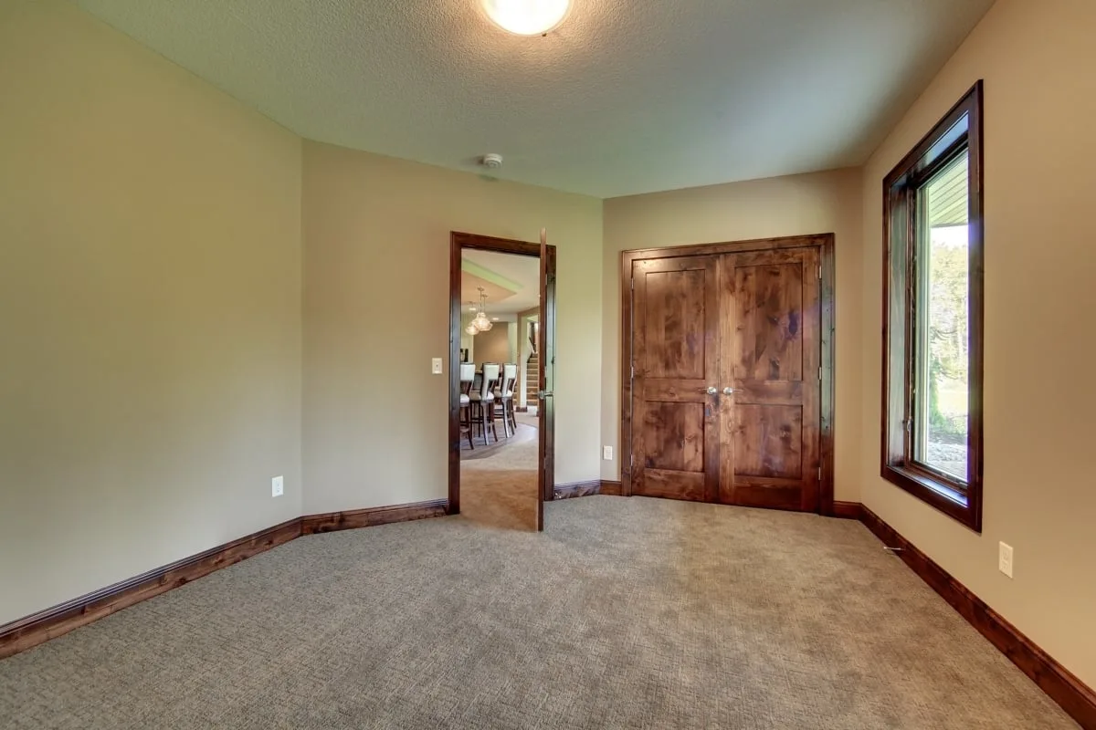 The bedroom closet is located behind the solid wood shut door near the entrance.