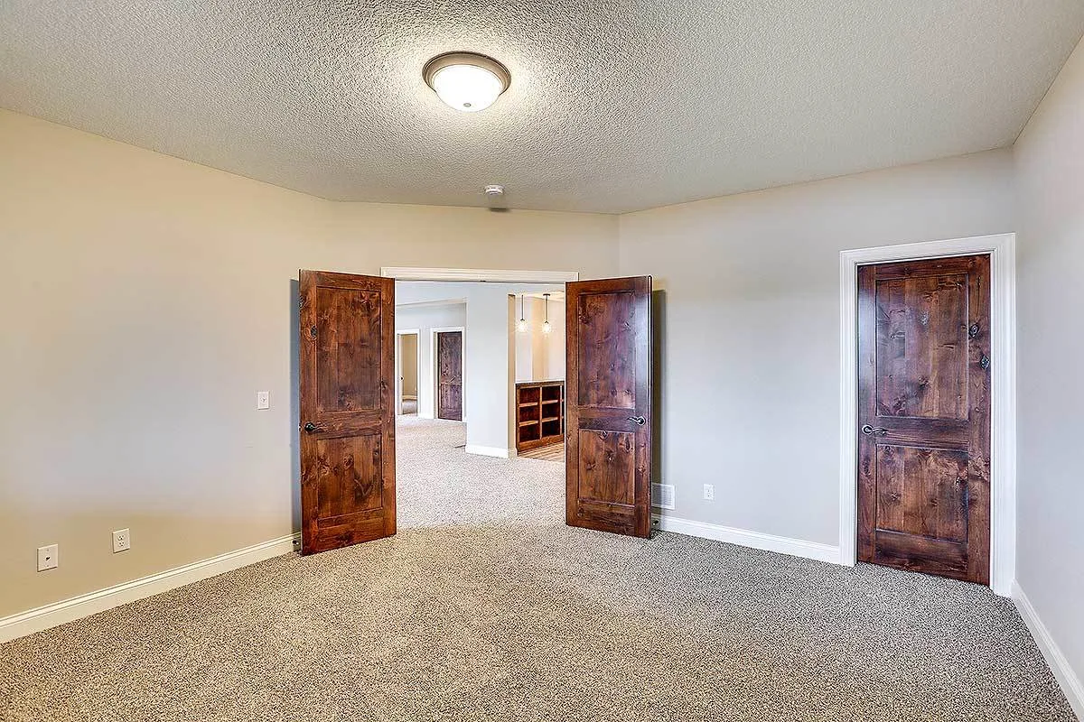 Bedroom door with a sturdy style and gray-colored walls.
