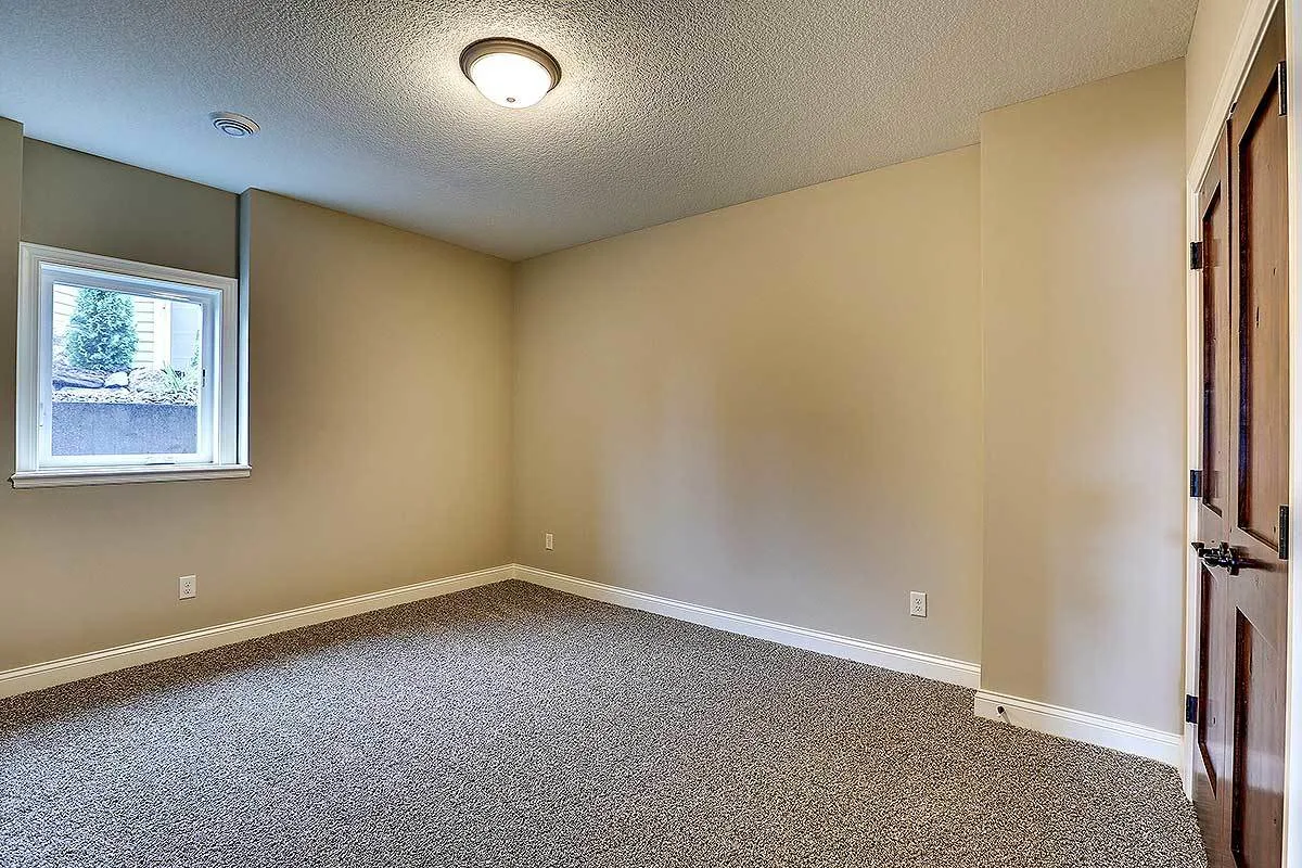 Bedoom area with gray carpet floor.