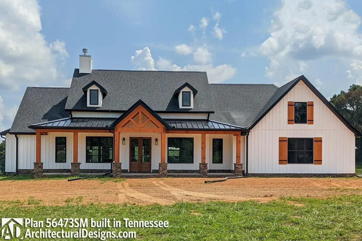 The front porch stands out, along with the wood-accented window shutters.