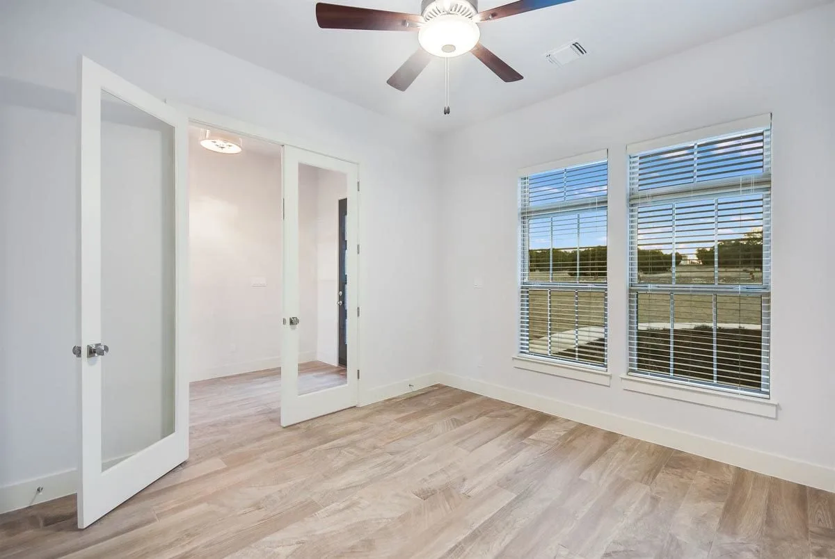White interior paint covers the office space with the door made of transparent glass.