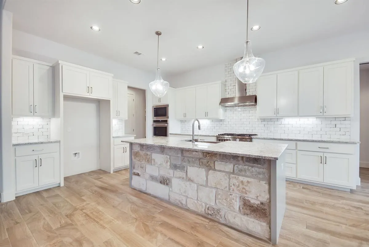 A contemporary kitchen with brilliant white cabinetry and appliances.