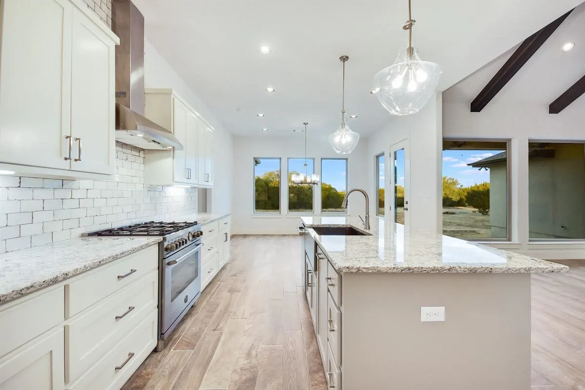 The kitchen area is created with white brickwork and marble countertops.
