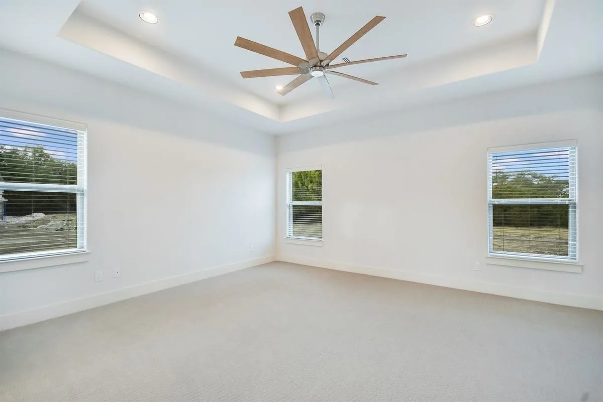 Area of the master bedroom with a tray ceiling design.