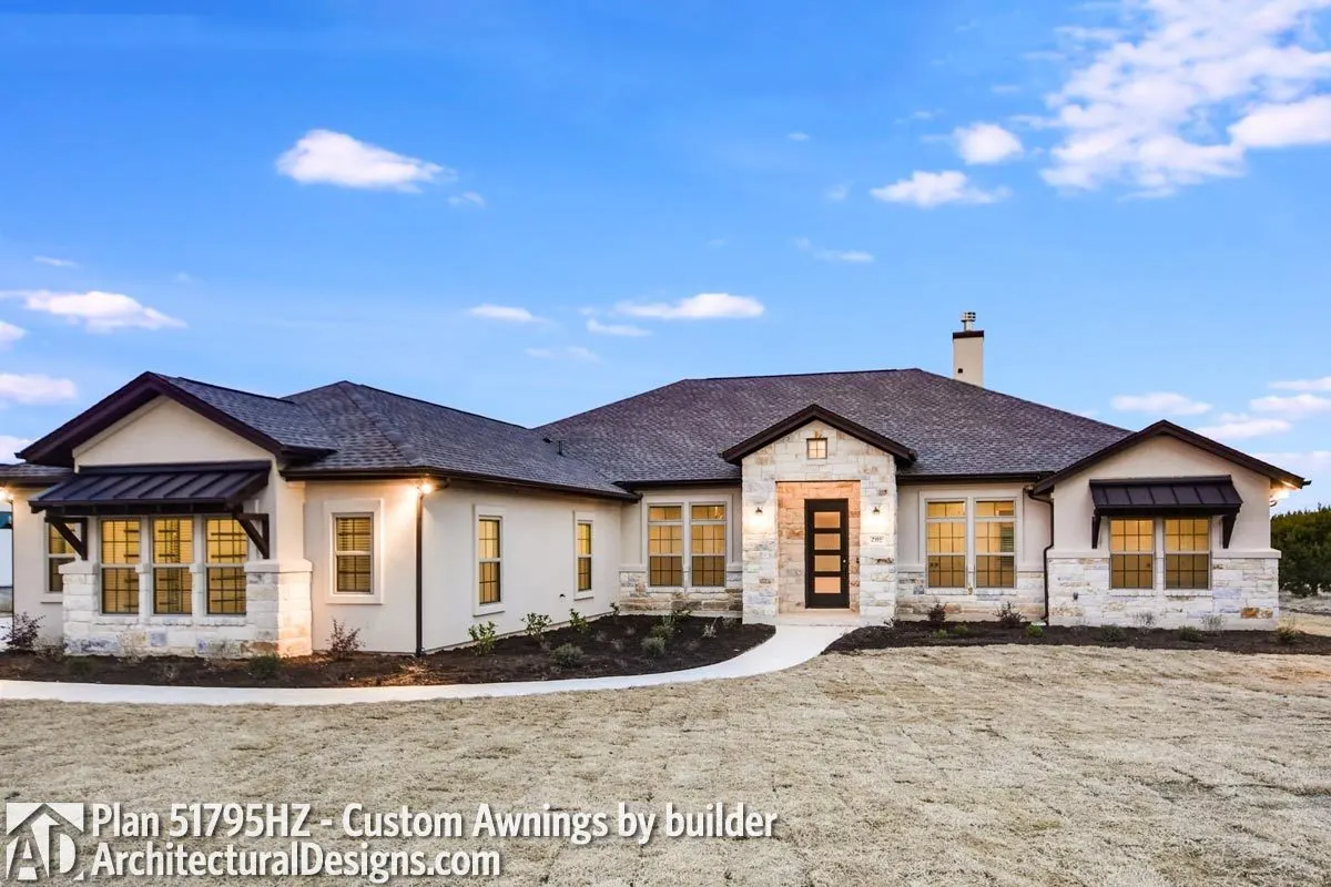 The exterior also includes window awnings in a dark brown tint.
