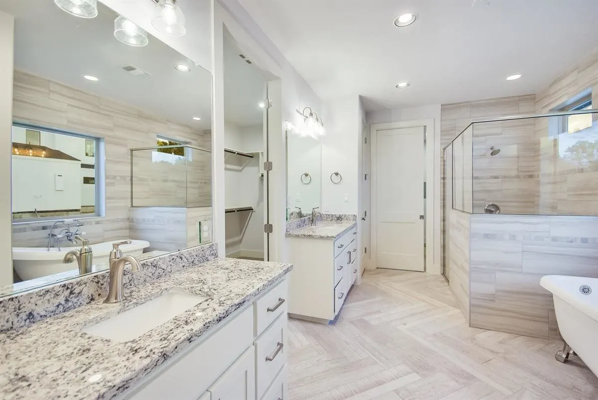 The master bathroom in sophisticated design interior with vanities on a marble counter.