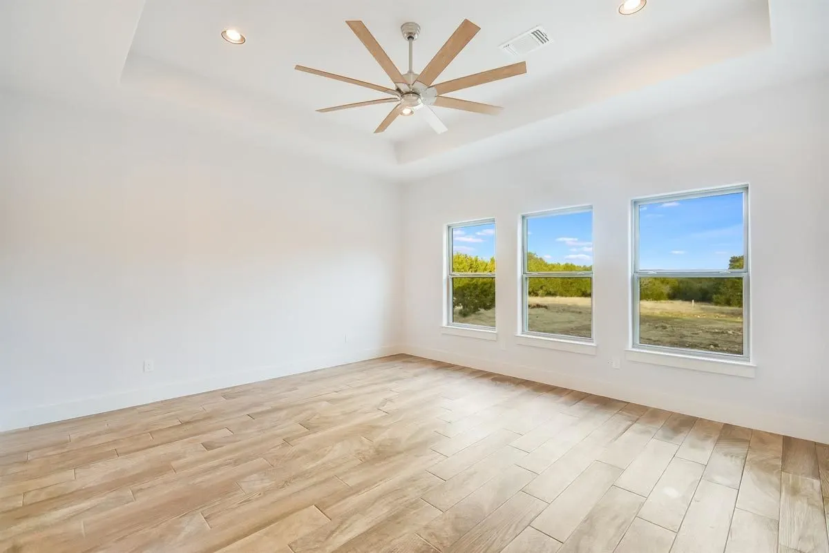 A game room with a serene interior atmosphere and wood tile flooring.