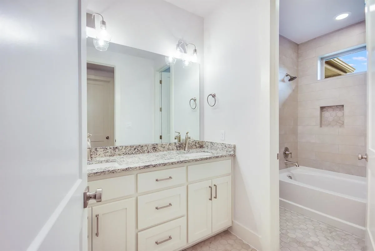 A beautiful bathroom with a tub as well as modern tile walls and floors.
