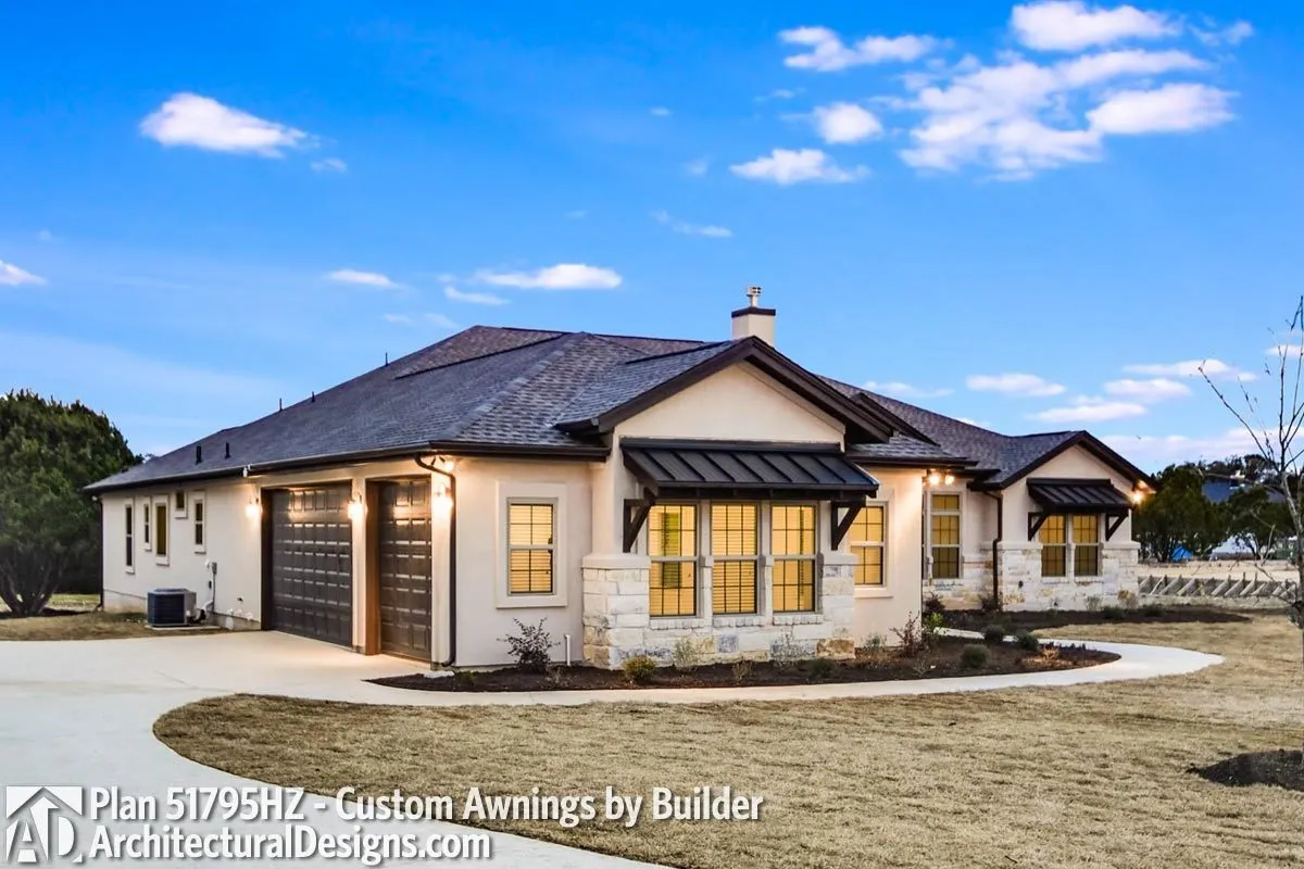 The house's left side has a three-car garage and a big driveway.