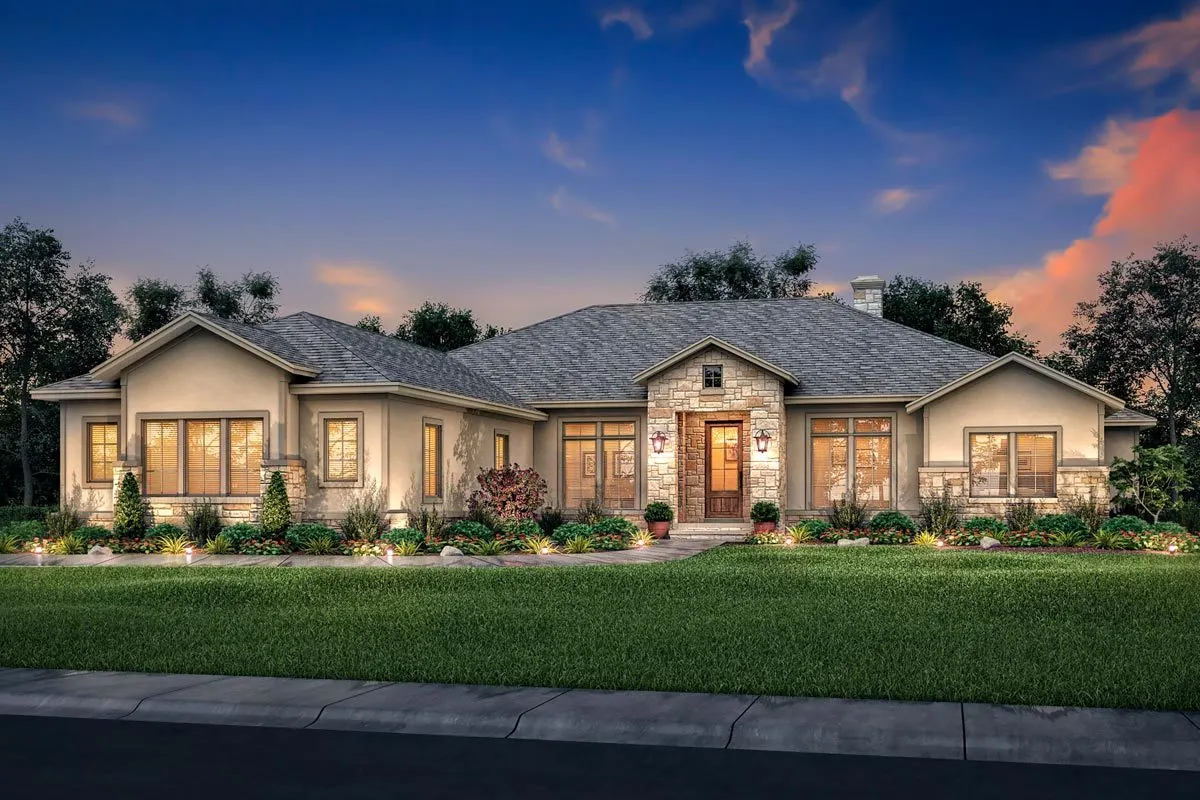 Beautiful landscaping in the front yard is lighted by lamp posts and walkway decor.