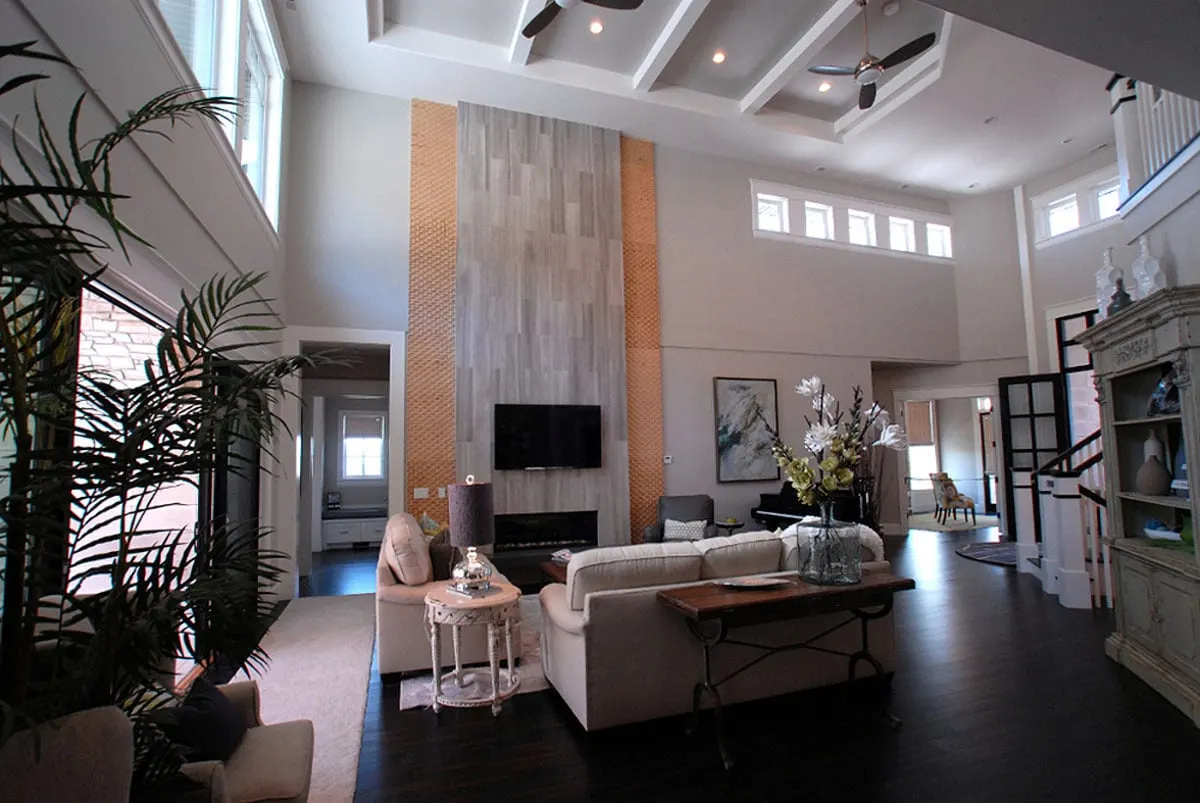 Spacious great room area with fireplace in elegant interior.