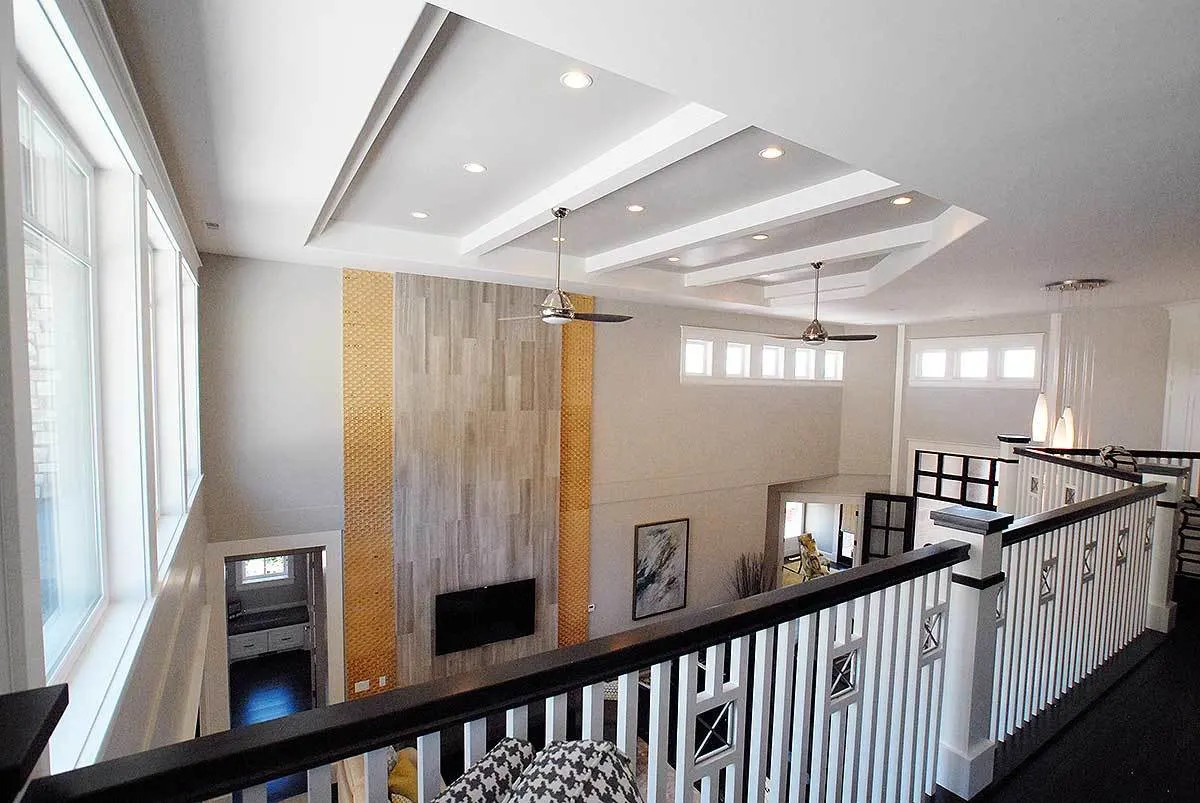 Loft area with wood railings and a view of the main level.