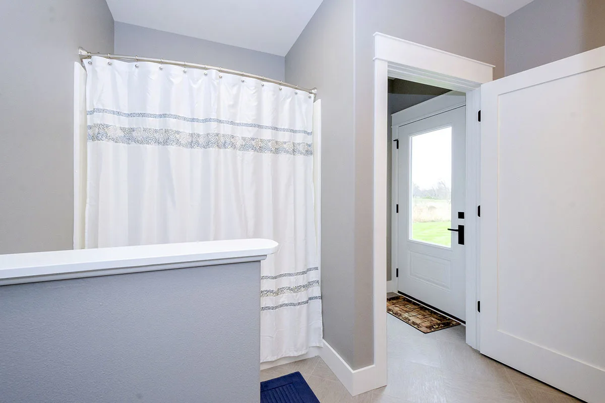 Nook with a curtain and door to the outside.