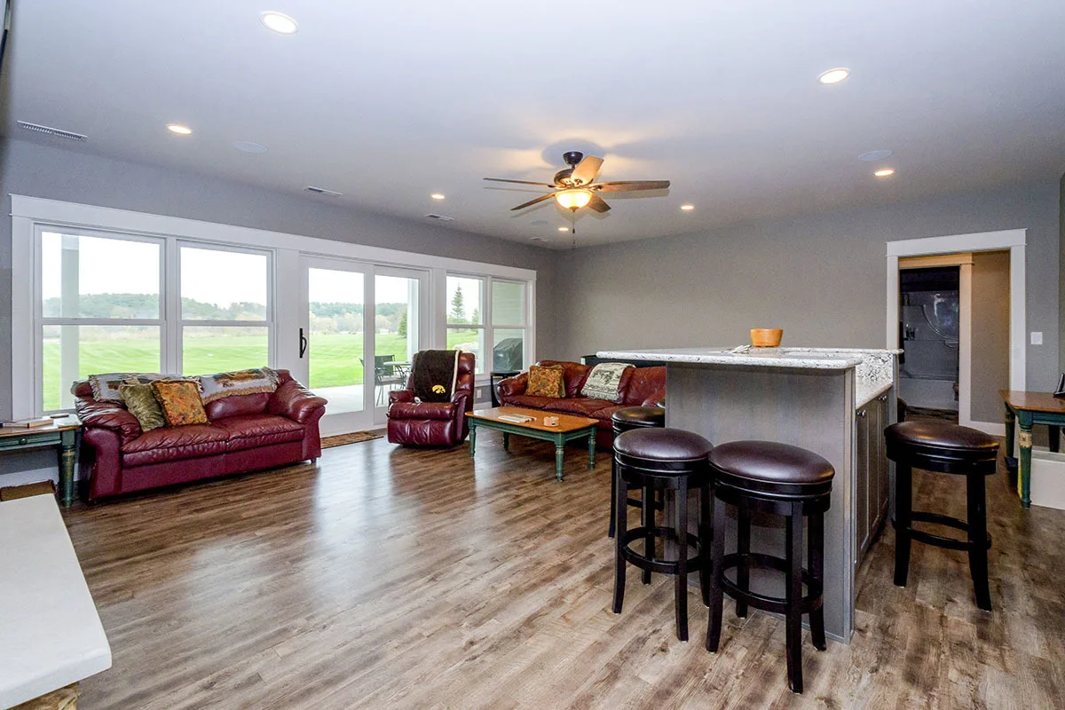 Family room with leather red seats and an entrance to the terrace.