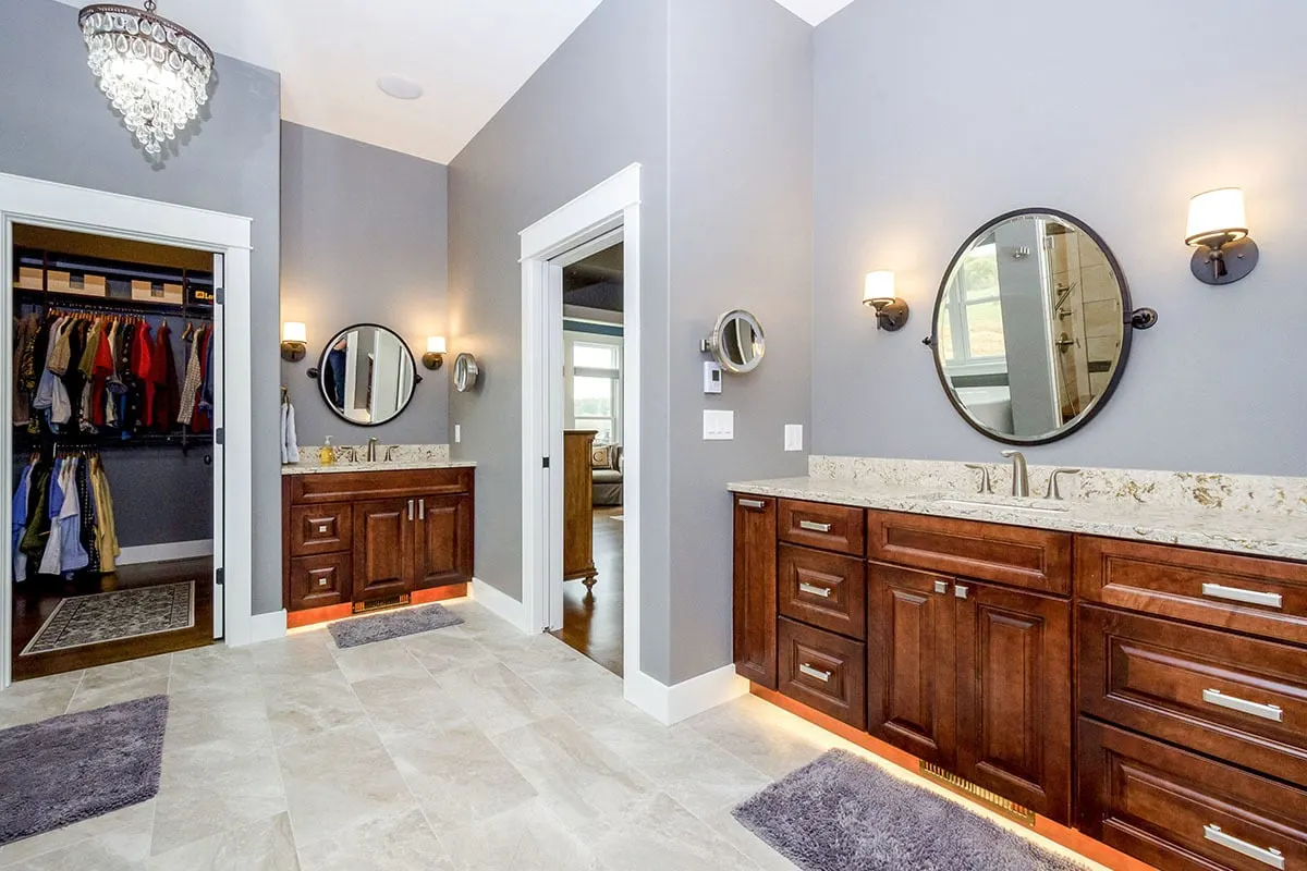 Solid wood vanities in the master bathroom are located next to the walk-in closet.